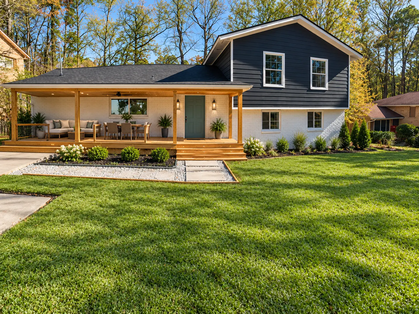 Design concept of the same house, with a finished wood porch with lights, a ceiling fan and furniture, planted beds and a green lawn